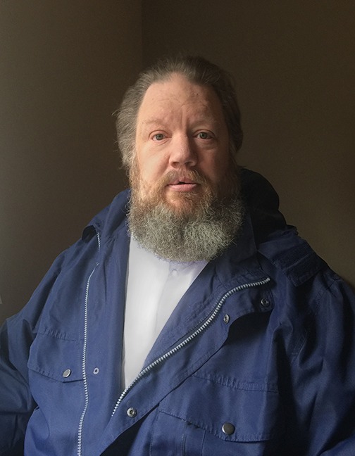 A person with a beard

AI-generated content may be incorrect.